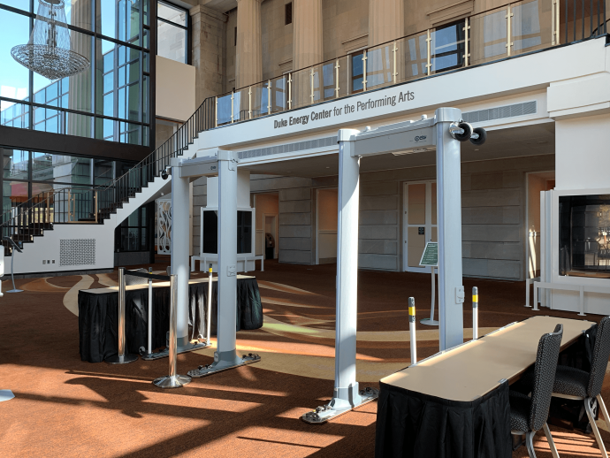An image an empty Raleigh Memorial Auditorium lobby showing two sets of metal detectors set up