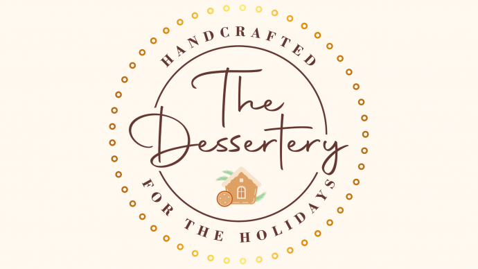 an image with a circle in the center it says The Dessertery and around the edges of the circle it says handcrafted at the top and the bottom of the circle says for the holidays there is a small gingerbread house in the center of the image